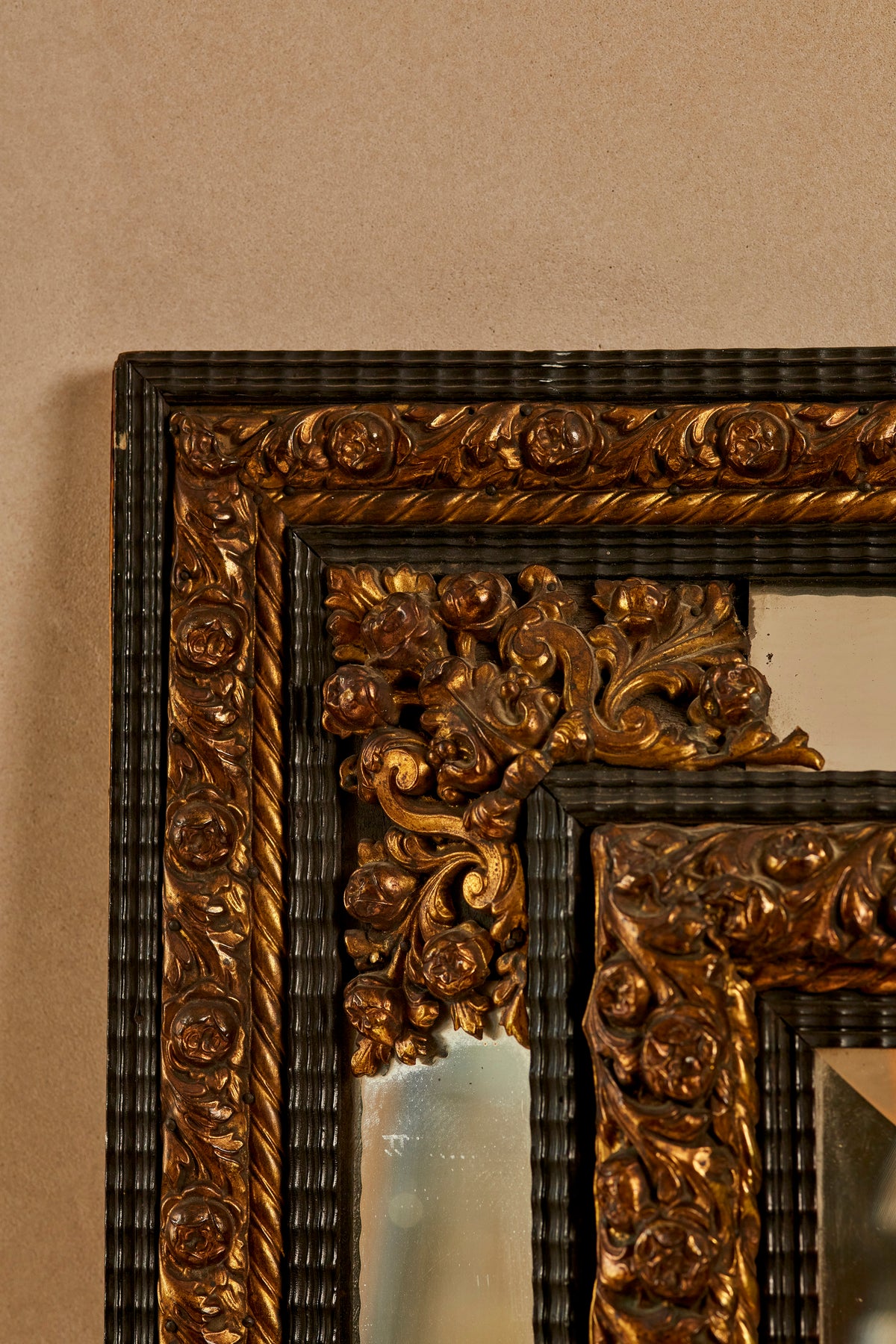 A Northern European Brass and Ebonised cushion mirror
