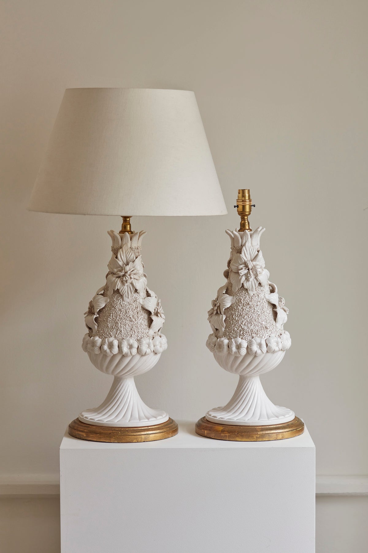 Pair of decorative table lamps with intricate designs on a neutral background