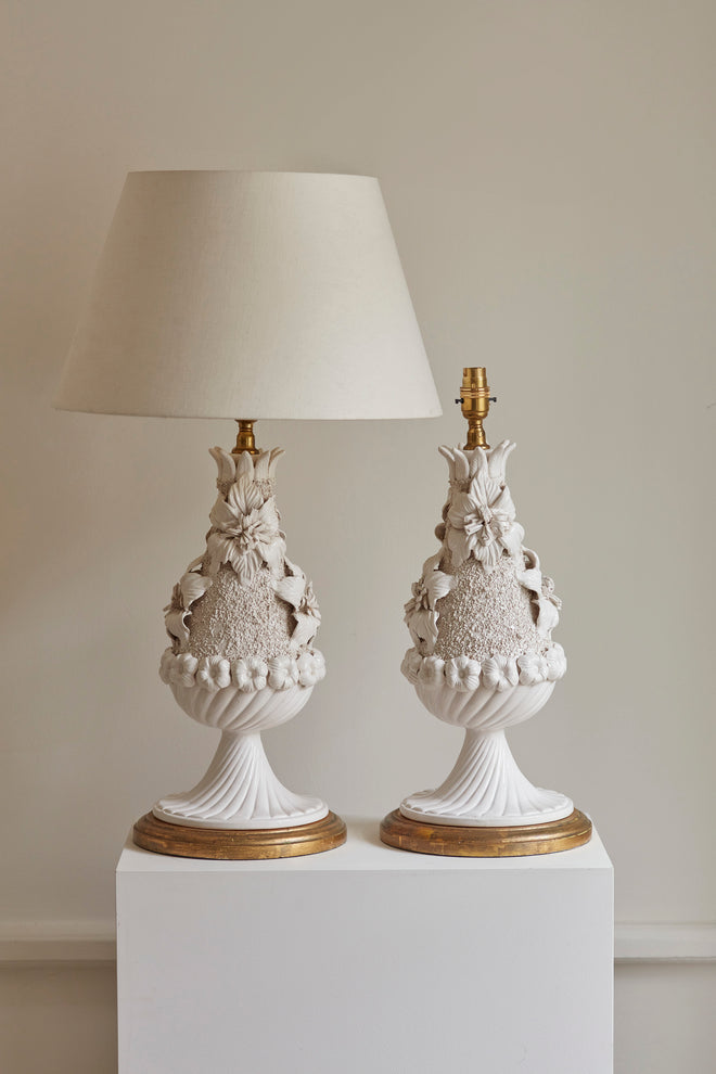 Pair of decorative table lamps with intricate designs on a neutral background