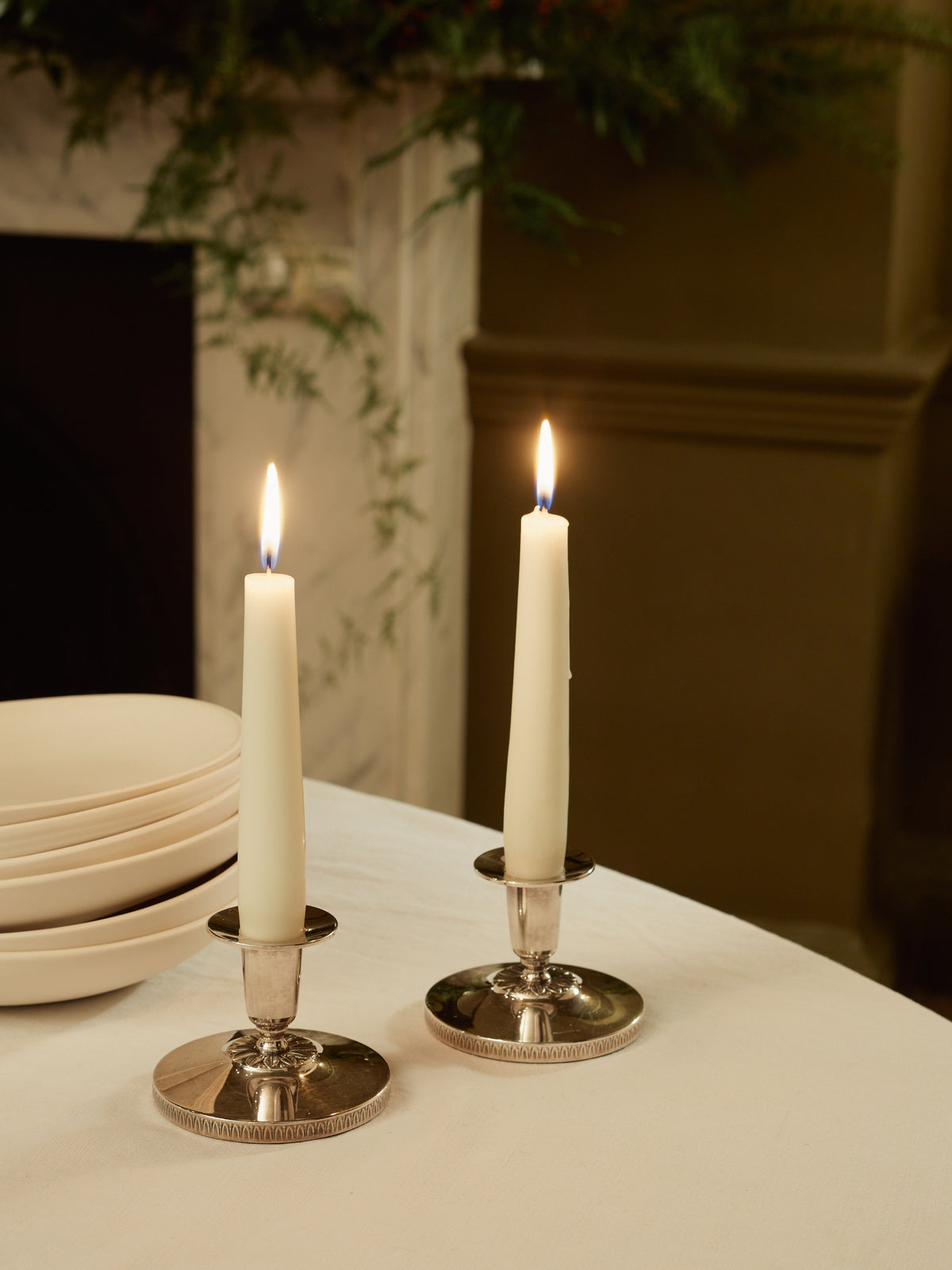 A Pair of Silver Candlesticks with Floral Motif