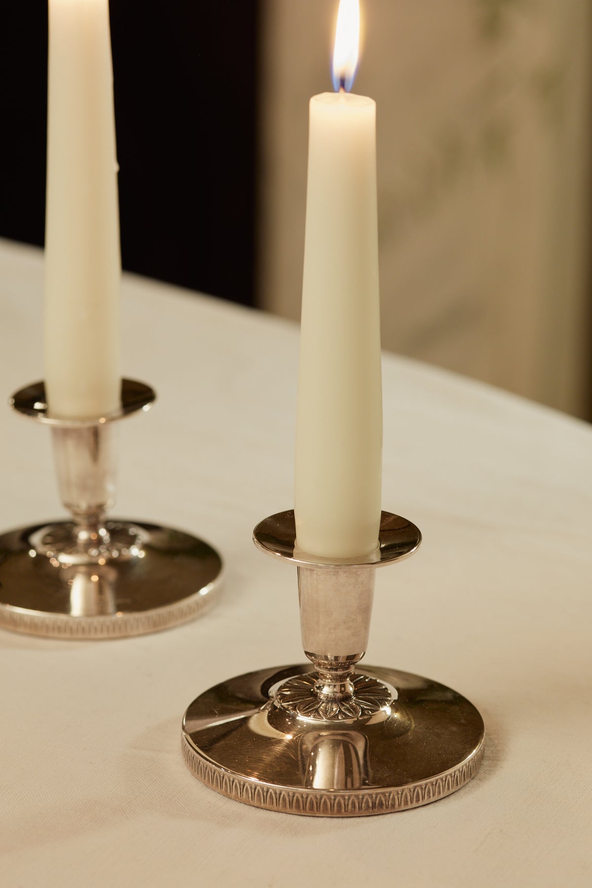A Pair of Silver Candlesticks with Floral Motif