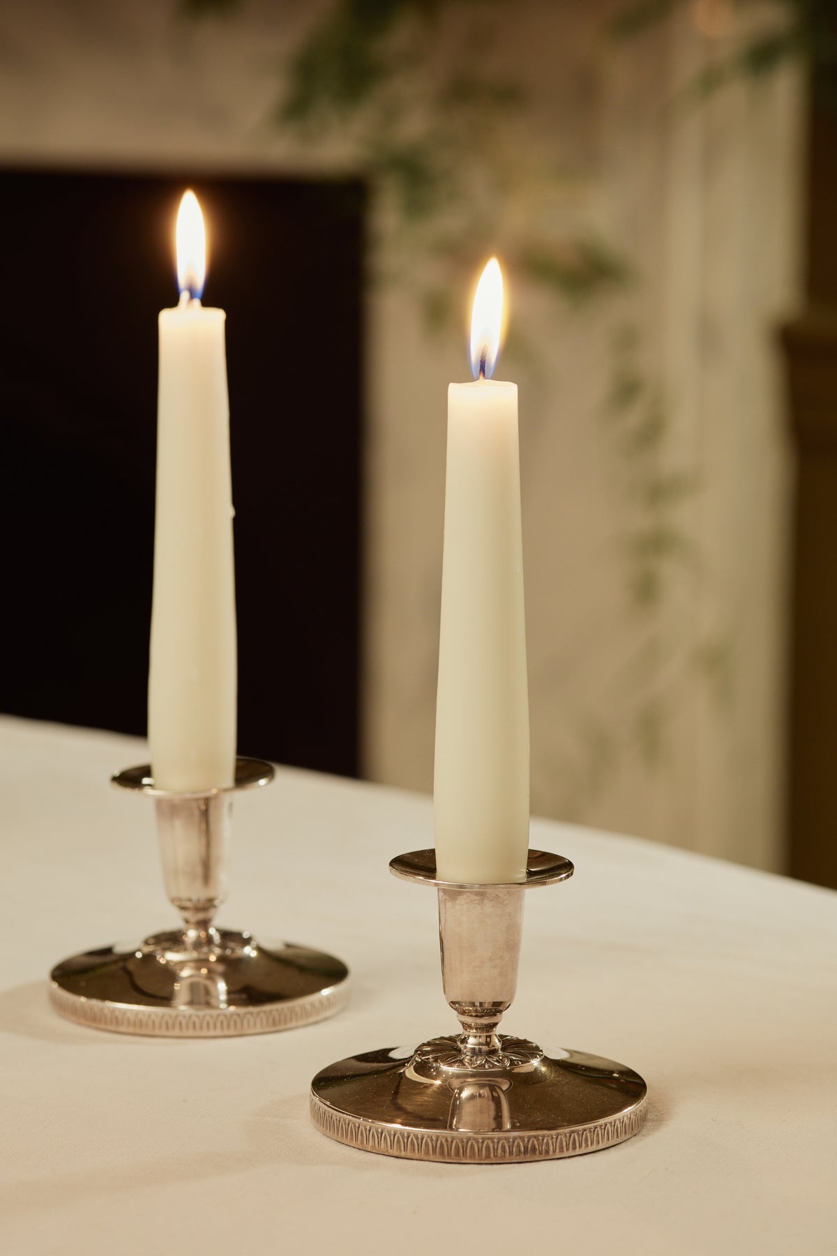 A Pair of Silver Candlesticks with Floral Motif